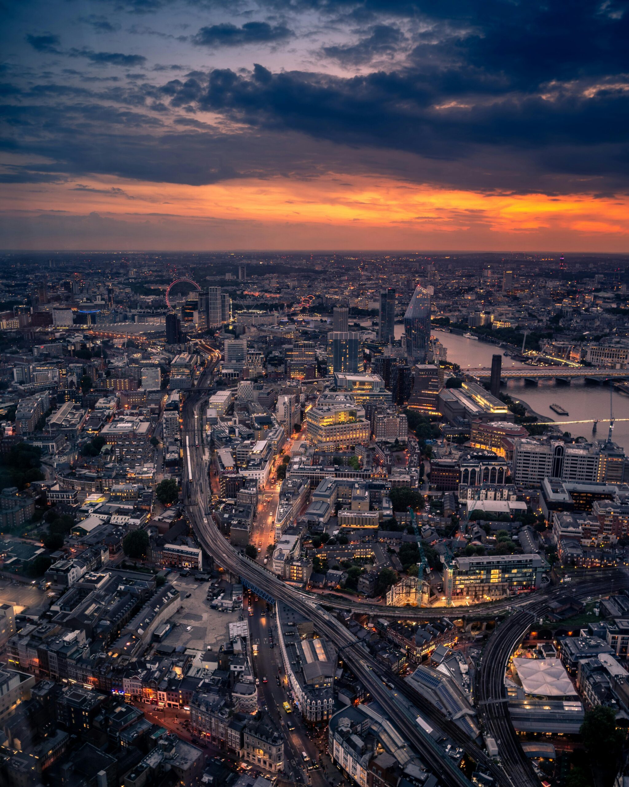 Captivating aerial view of London at twilight with city lights and skyline.
